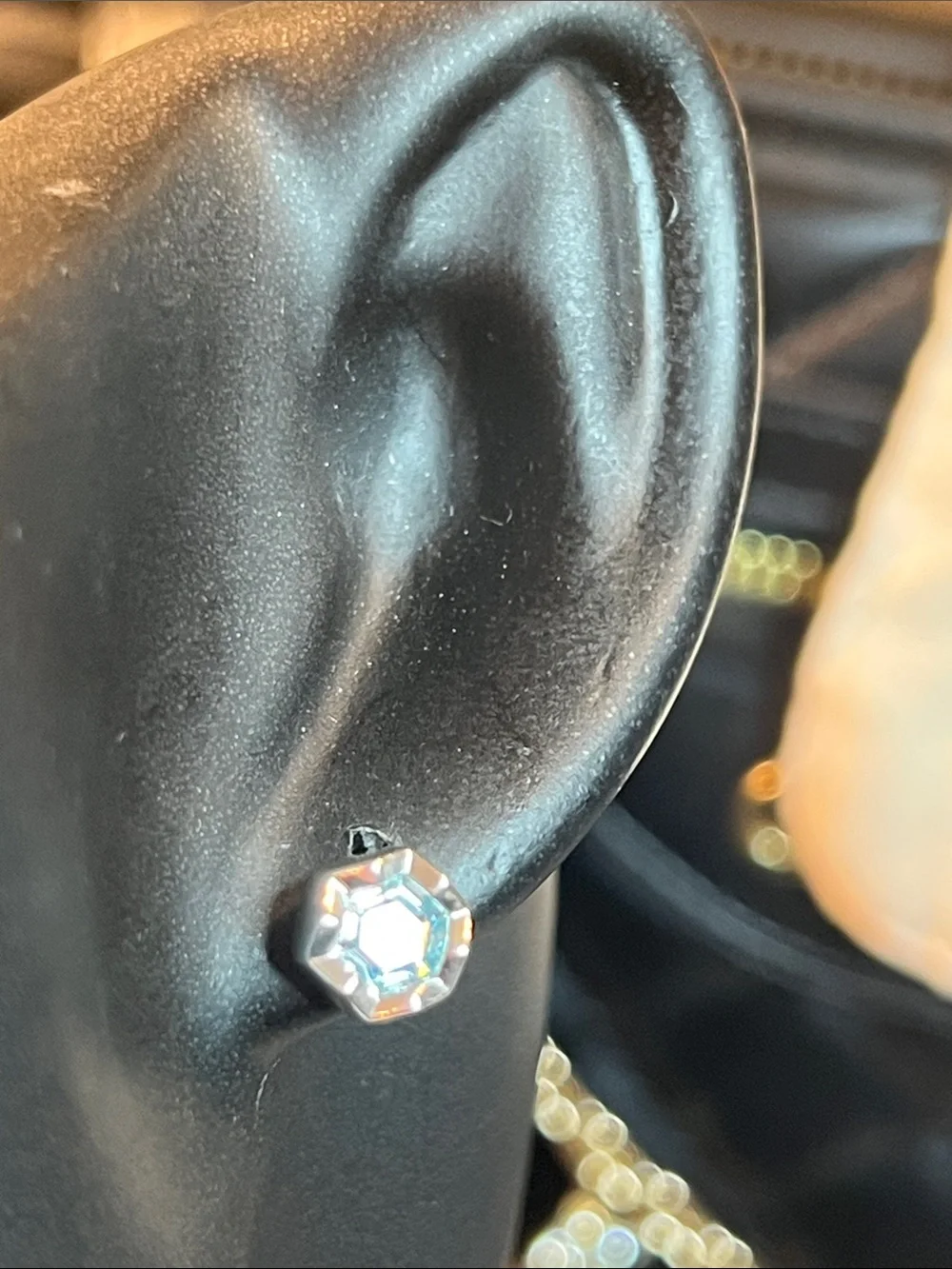 Round  Blue Zirconia In a Gold Setting With Logo